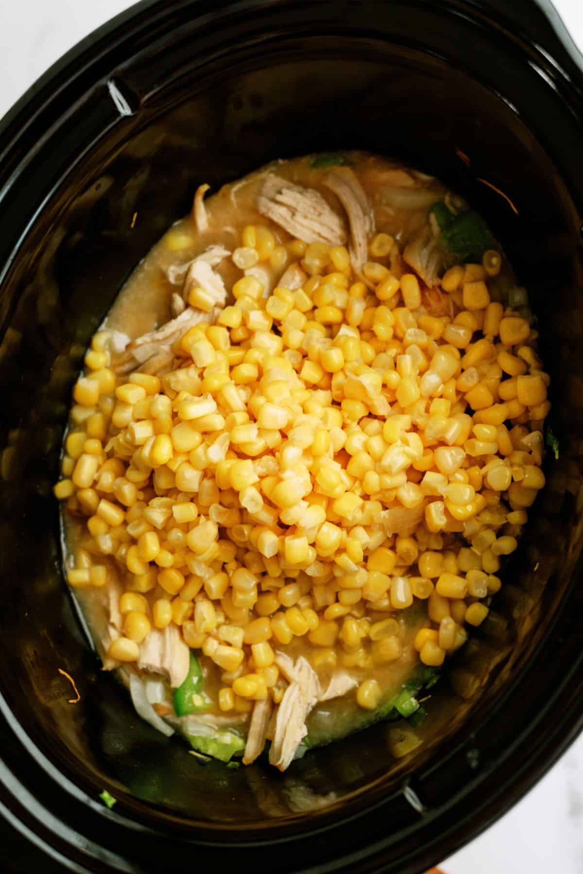 Ingredients for Slow Cooker Cheesy Chicken and Rice placed in the slow cooker