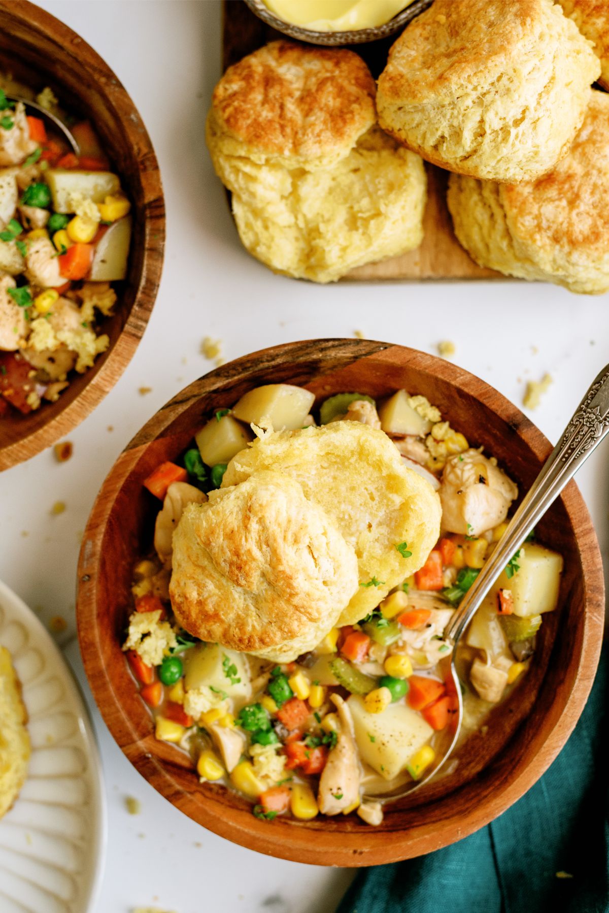 A bowl of Slow Cooker Chicken Pot Pie with 2 biscuits on top
