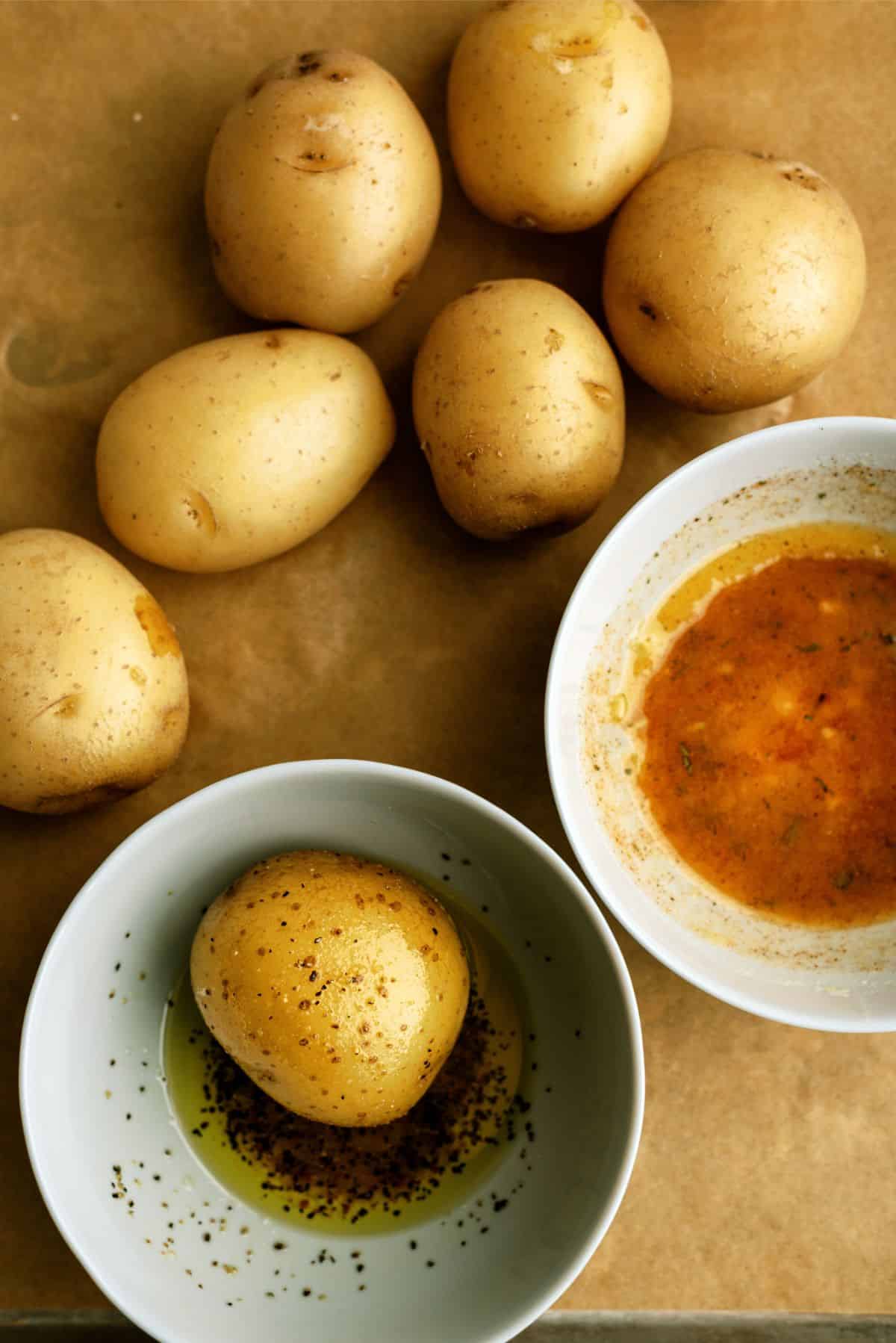 Mini Gold Potatoes a bowl of seasoning and a bowl of butter