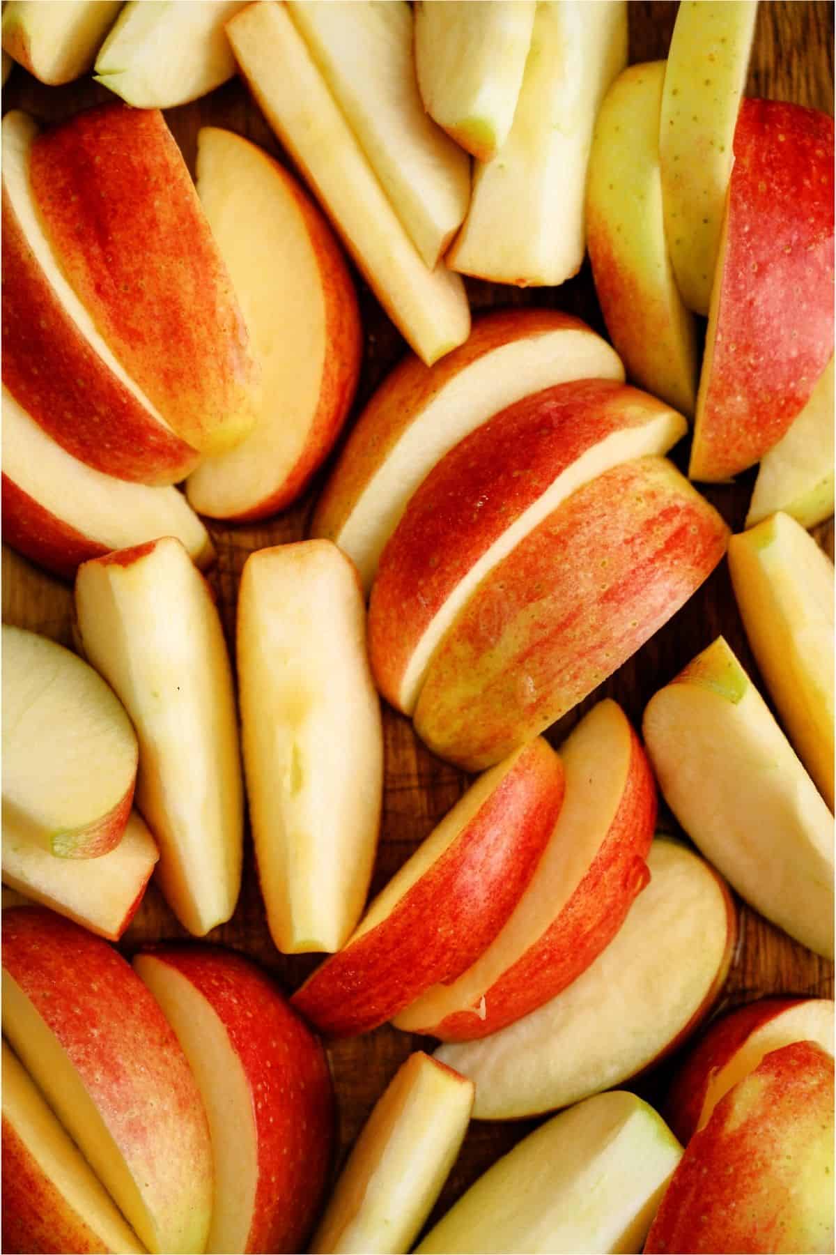 Sliced Apples on a wooden background.