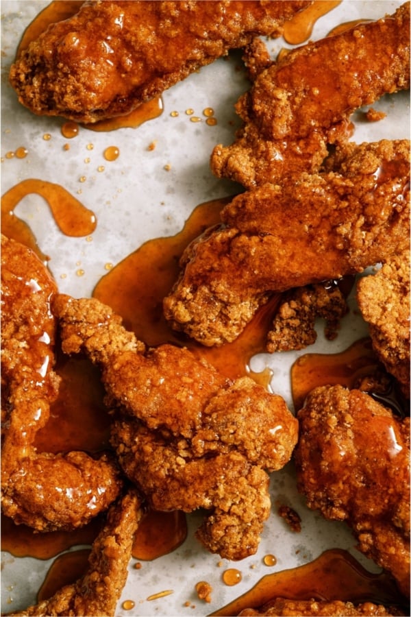 Top view of Winger’s Copycat Sticky Fingers on a sheet pan, with sauce on top.