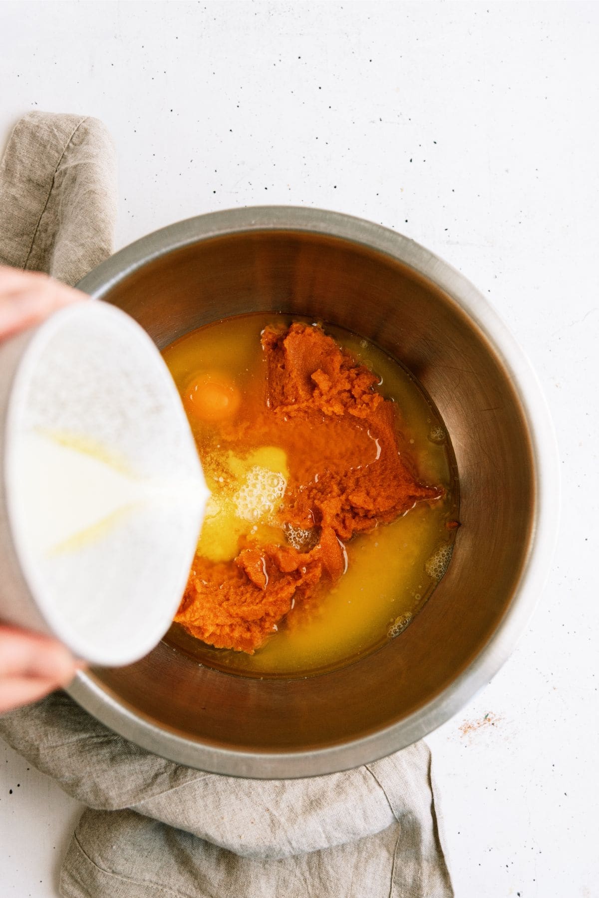 Pouring dry ingredients mixture into the bowl with wet ingredients