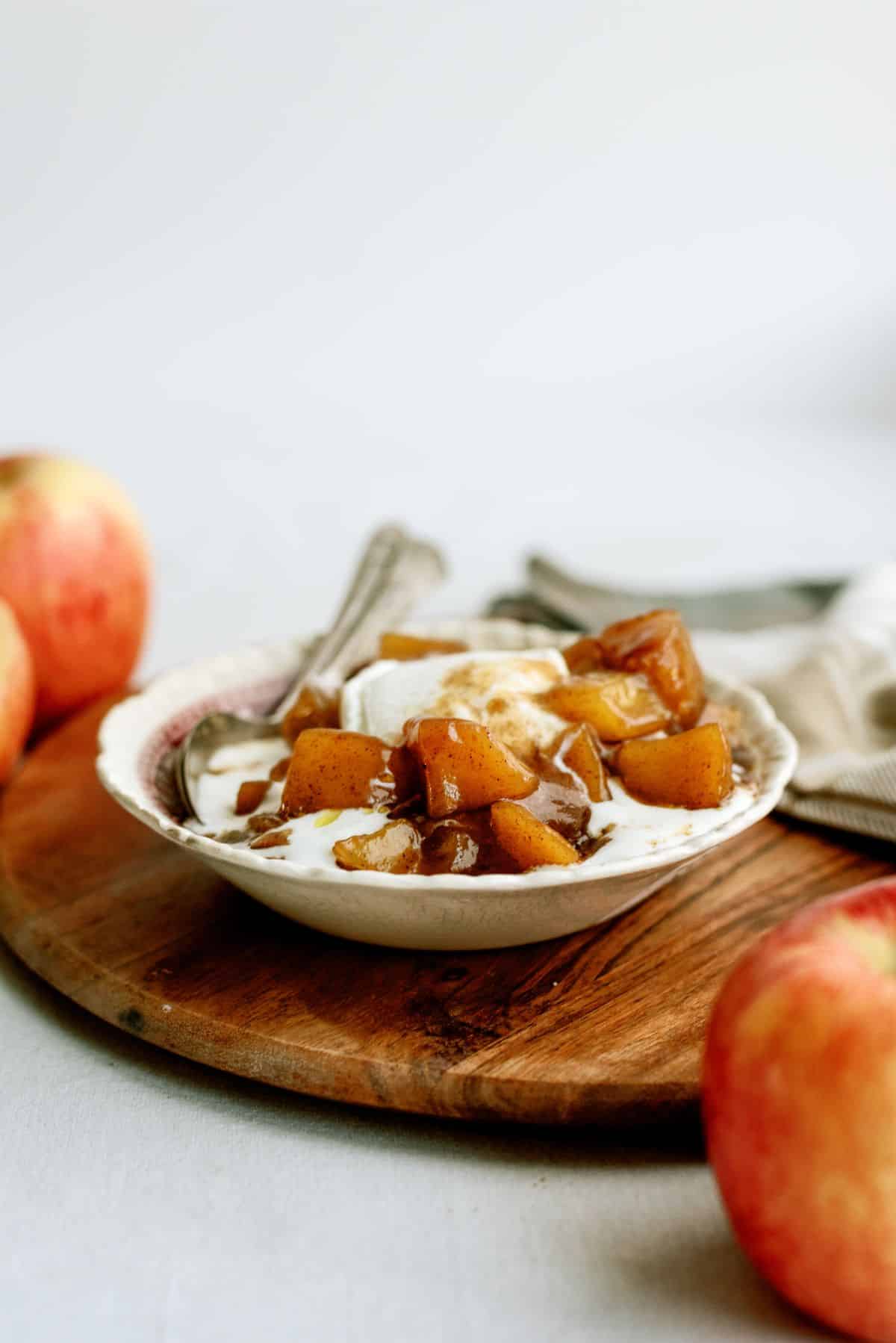 A bowl of Copycat Cracker Barrel Cinnamon Apples (in the Slow Cooker) with vanilla ice cream.