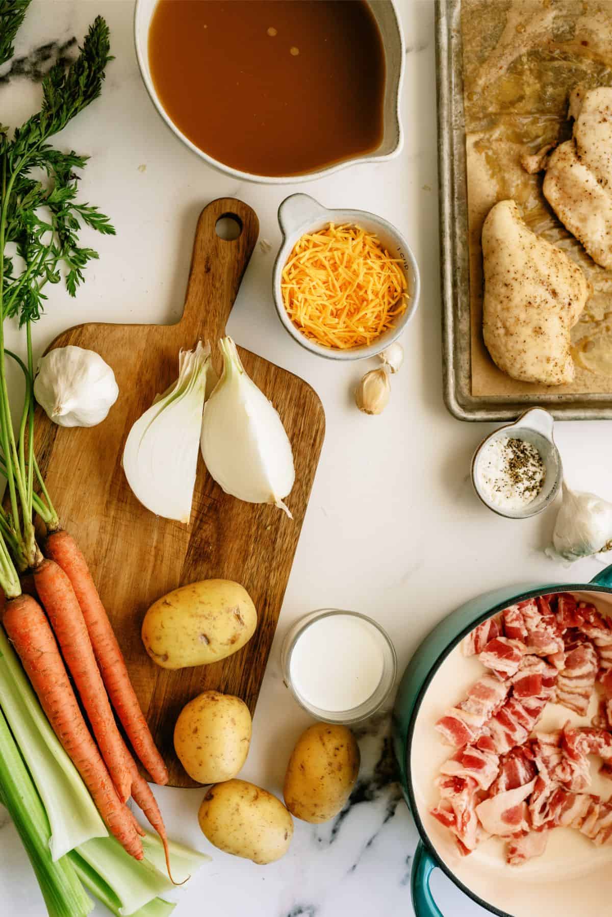 Ingredients needed to make Creamy Chicken and Potato Soup on a countertop.