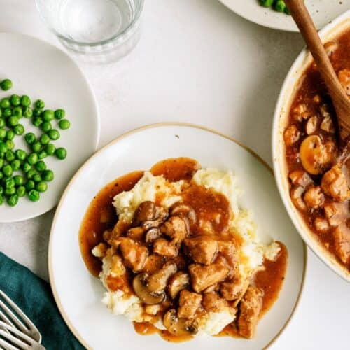 Top view of Instant Pot Pork Tips and Gravy served over a plate of mashed potatoes.