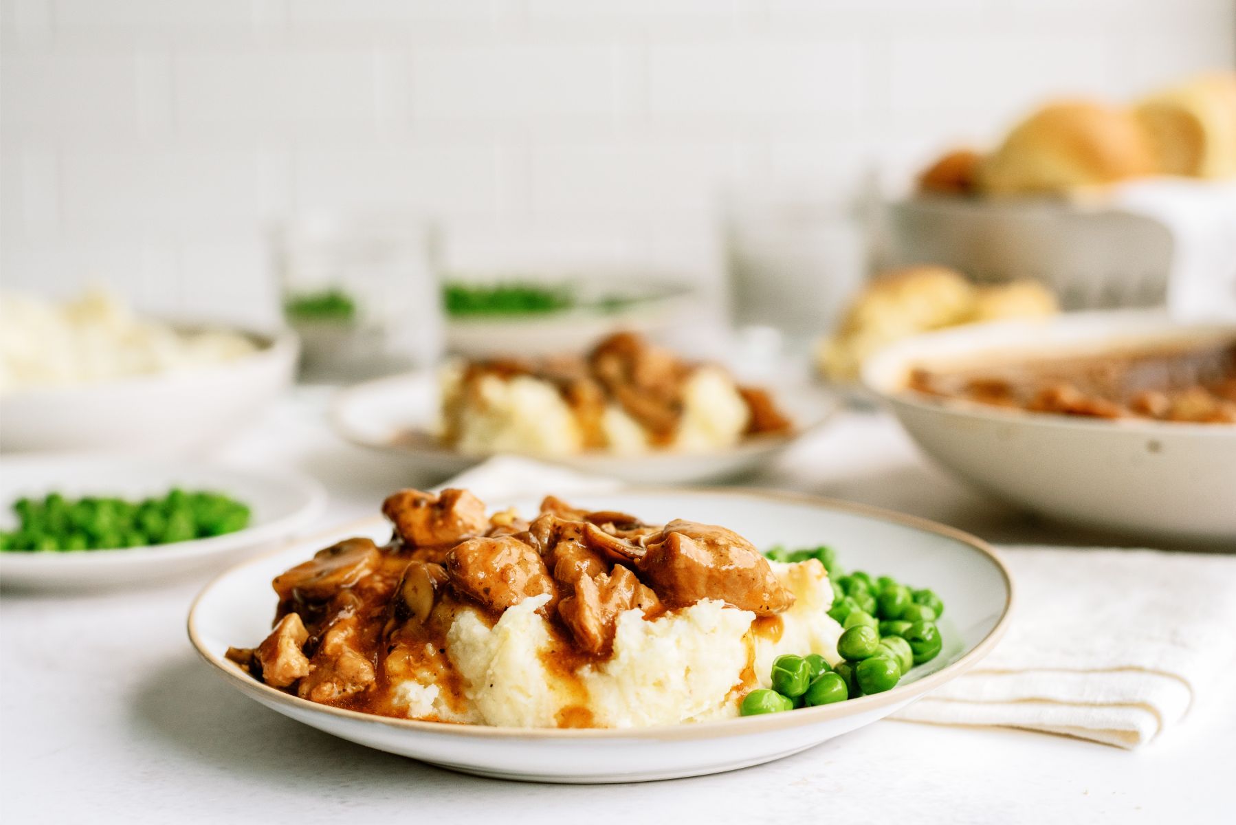 Instant Pot Pork Tips and Gravy served on top of mashed potatoes