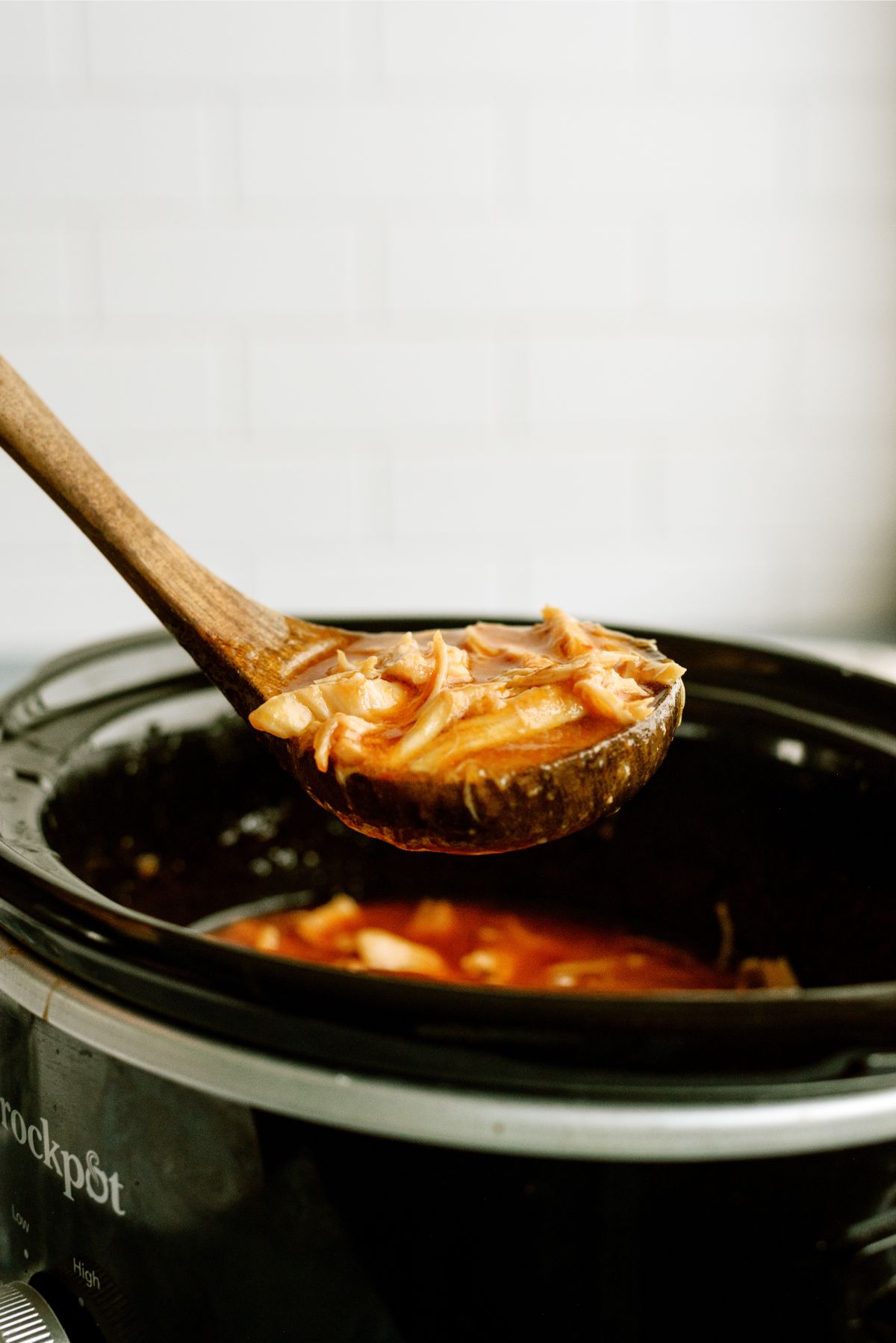 A spoonful of Slow Cooker Apricot Chicken out of the slow cooker