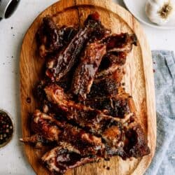 Top view of separated St. Louis Slow Cooker Ribs on a cutting board.