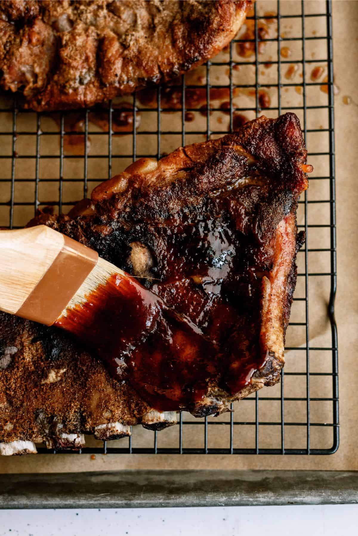 Brushing BBQ sauce on Slow Cooker St. Louis Ribs