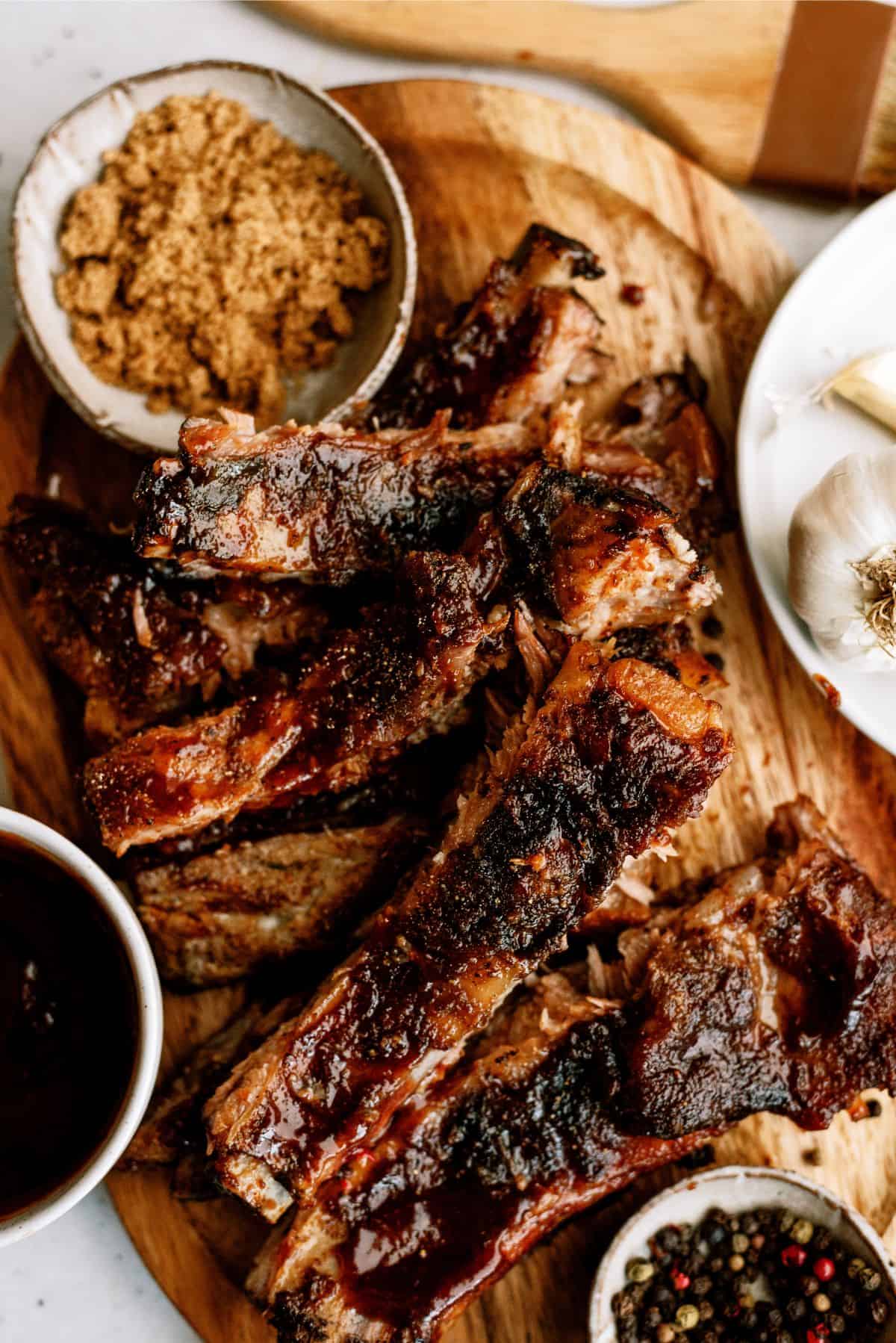 Slow Cooker St. Louis Ribs on a cutting board surrounded by spices