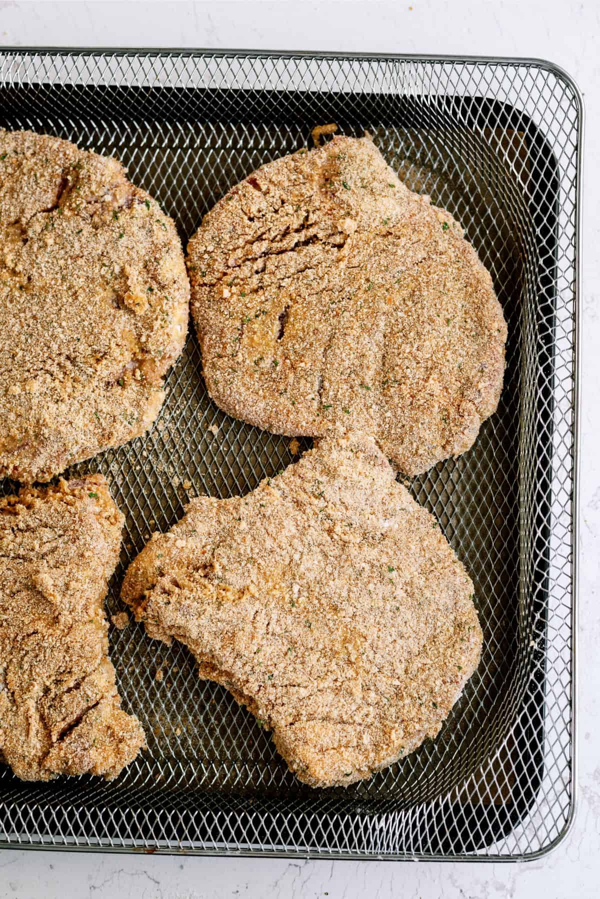 Cube steaks dipped in breading and ready to be air fried