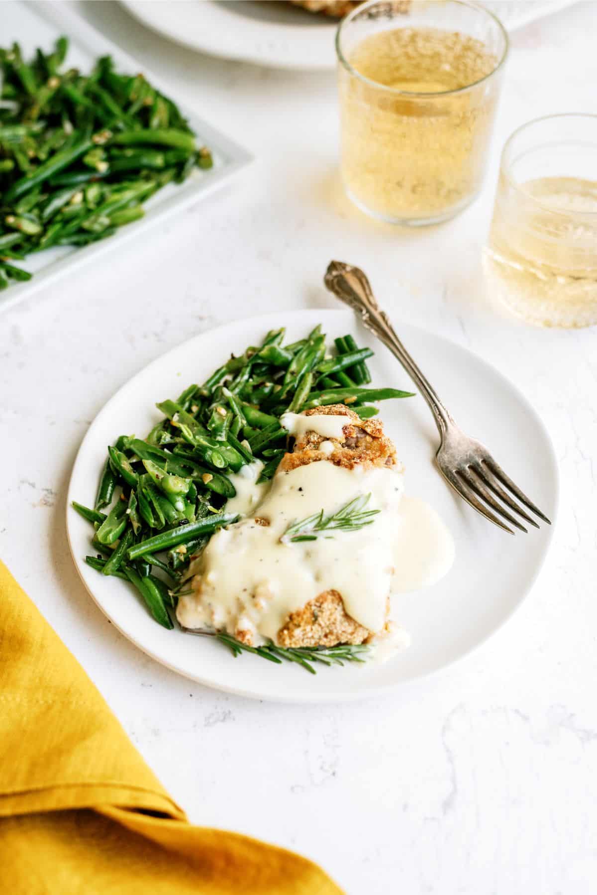 Air Fryer Cube Steak with Gravy served on a plate with greens