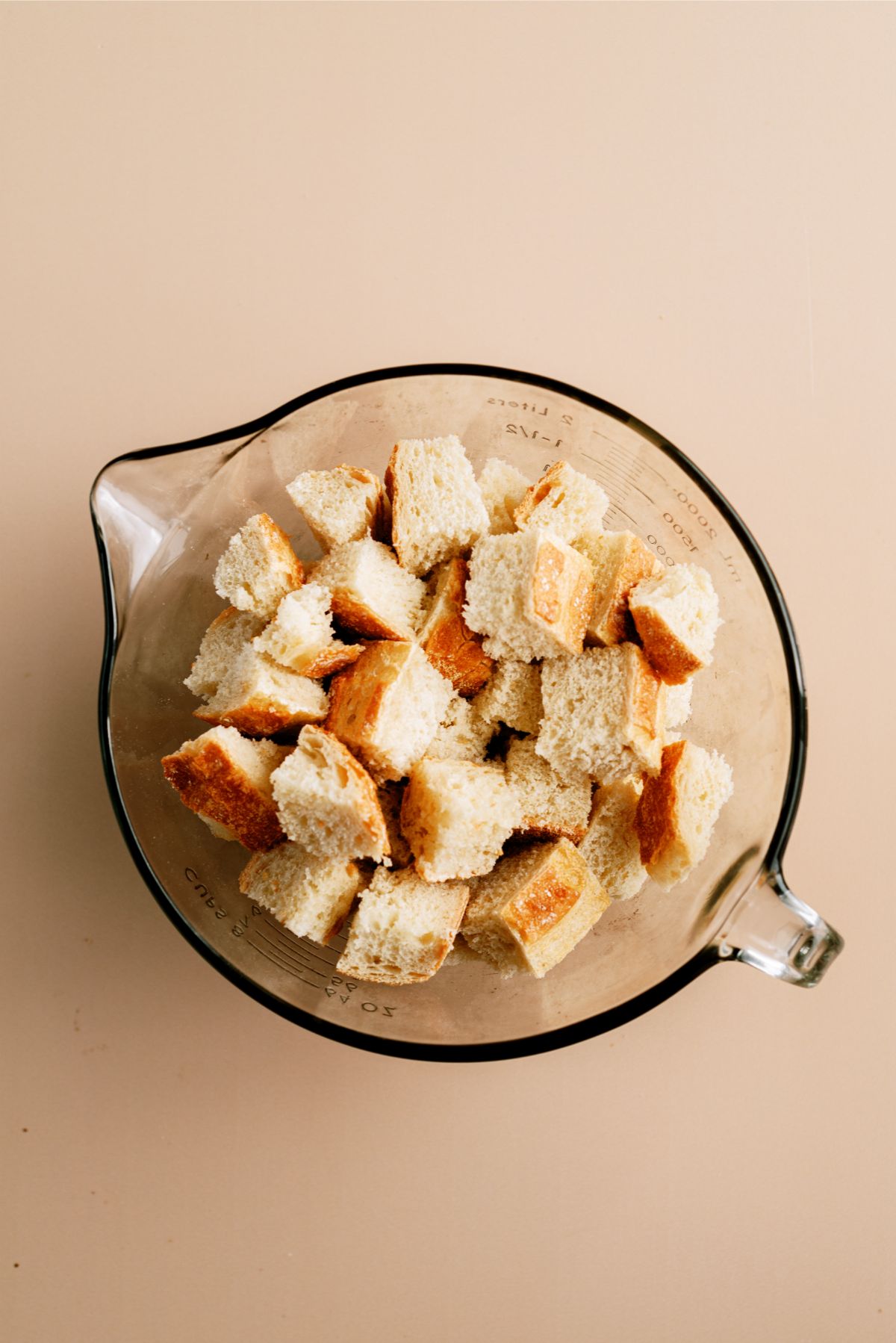 Cubed bread in a mixing bowl