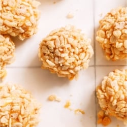 Top view of several Caramel Marshmallow Rice Krispie Balls on a white background.