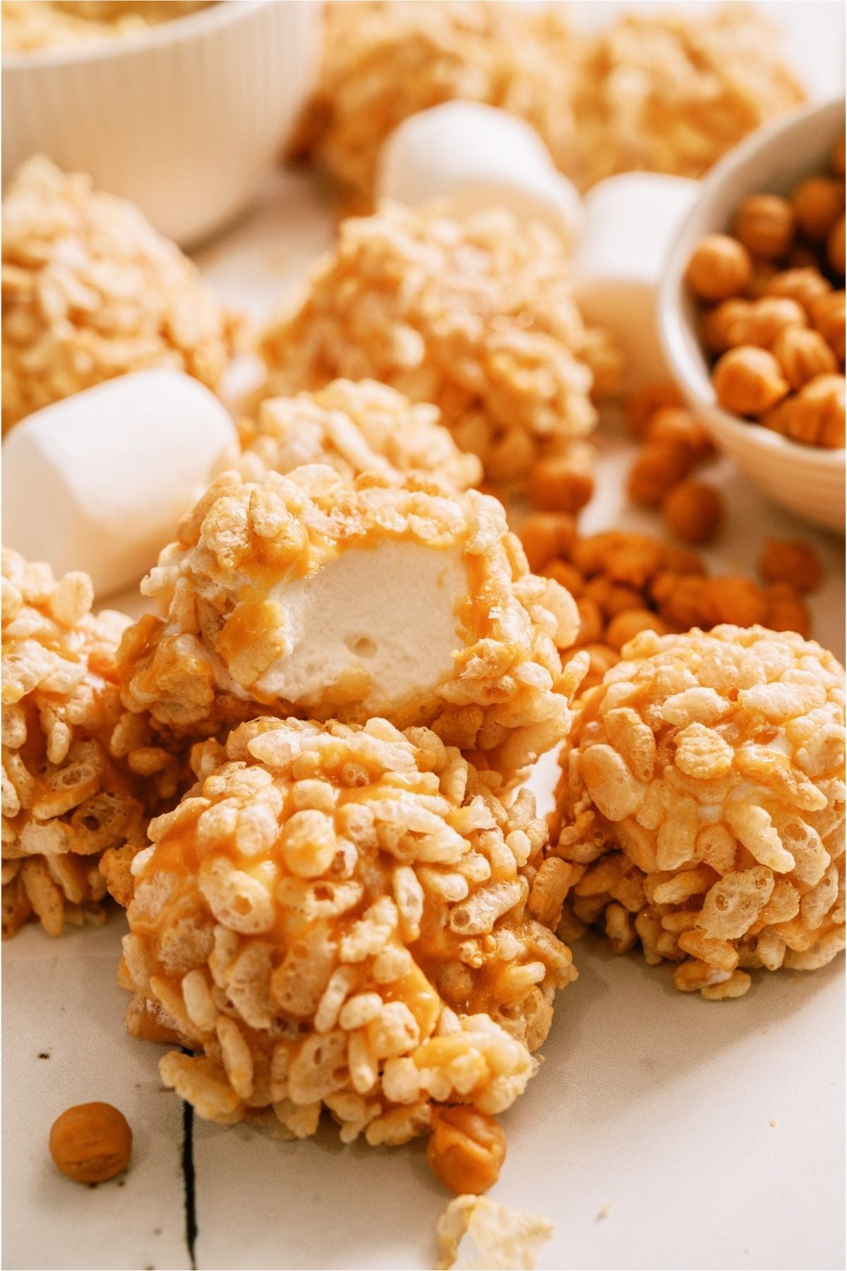 Caramel Marshmallow Rice Krispie Balls with one missing a bite.