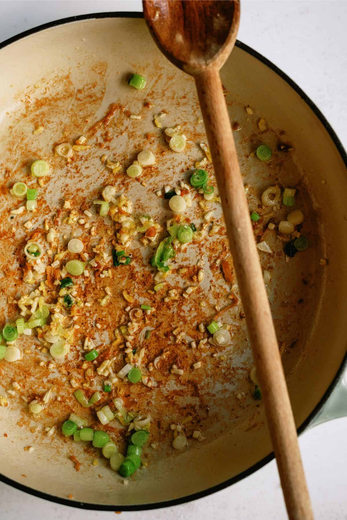 Sauteing onions and scallions in pan