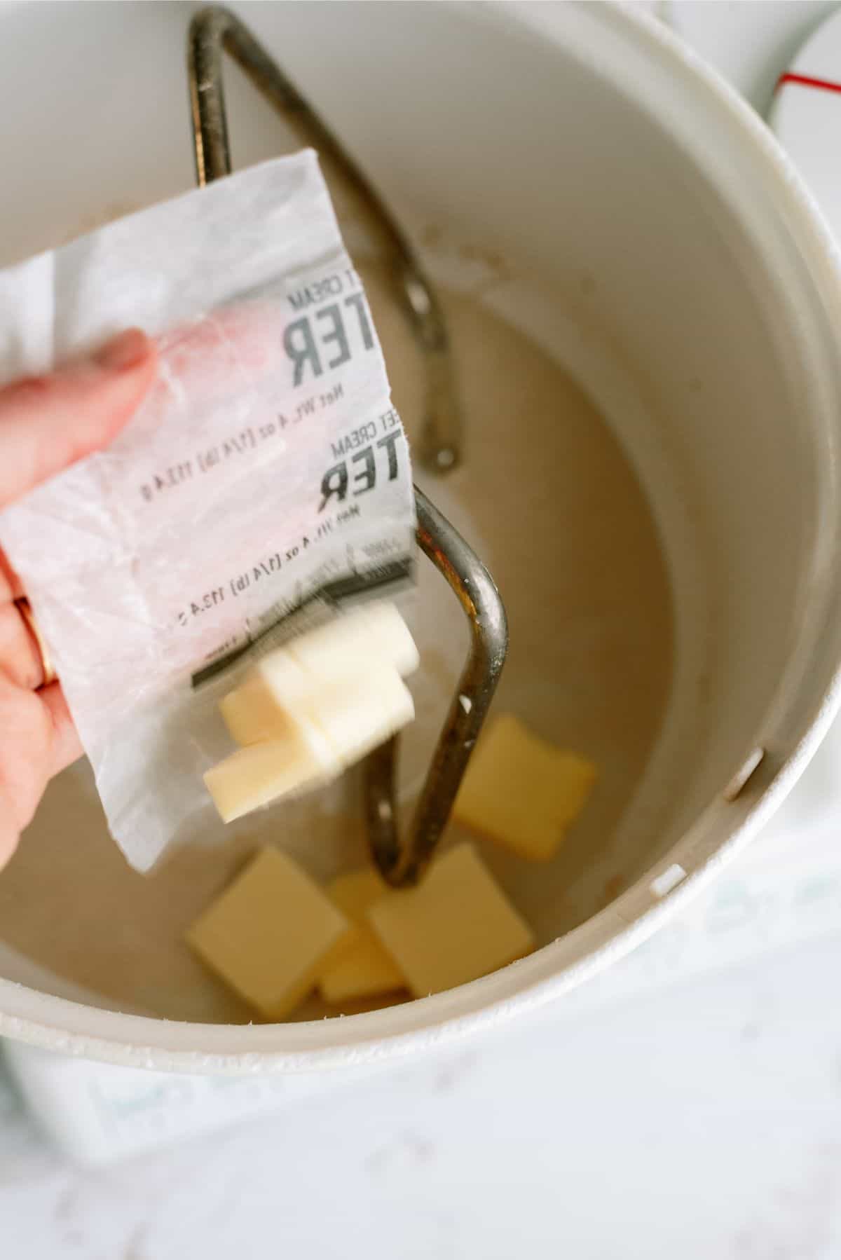 Adding softened butter to stand mixer