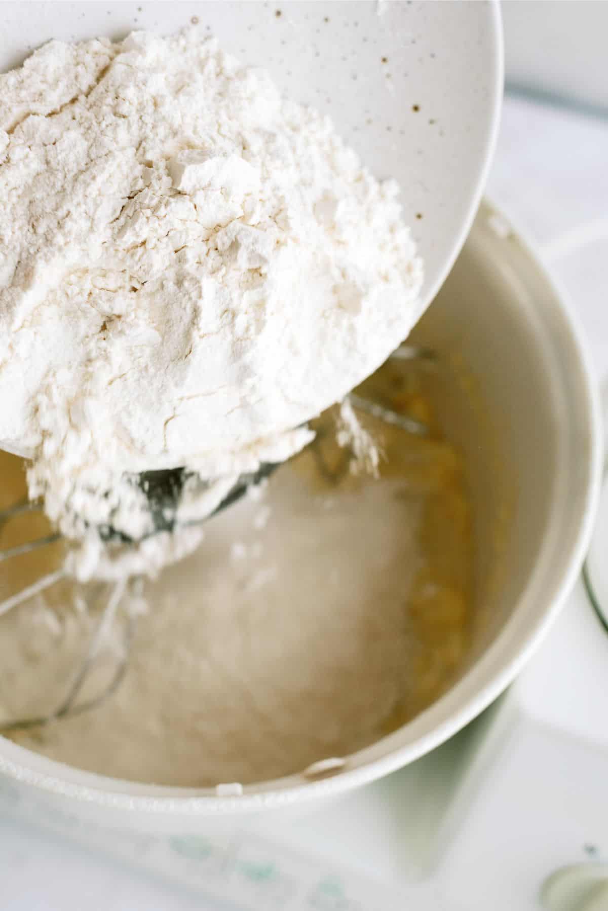 Adding flour mixture to stand mixer