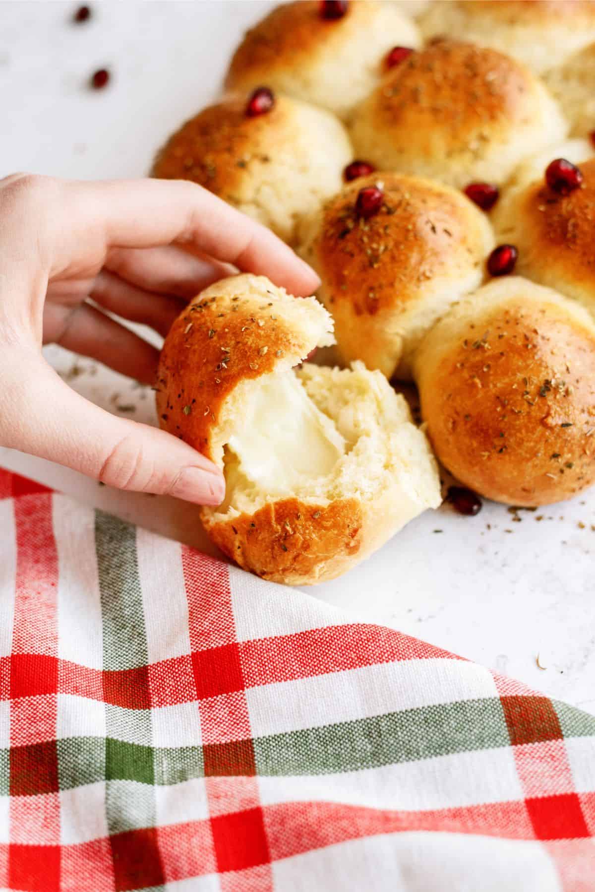 Christmas Tree Dinner Rolls with one opened in half showing the cheese