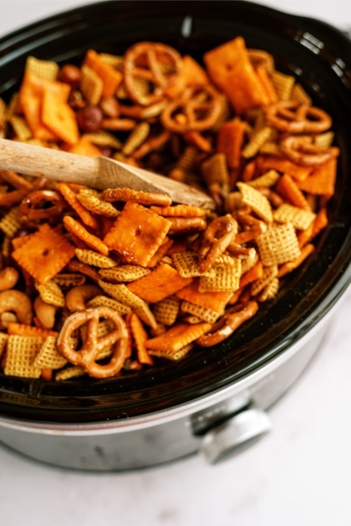 Slow cooker full of Slow Cooker Savory Chex Mix ingredients