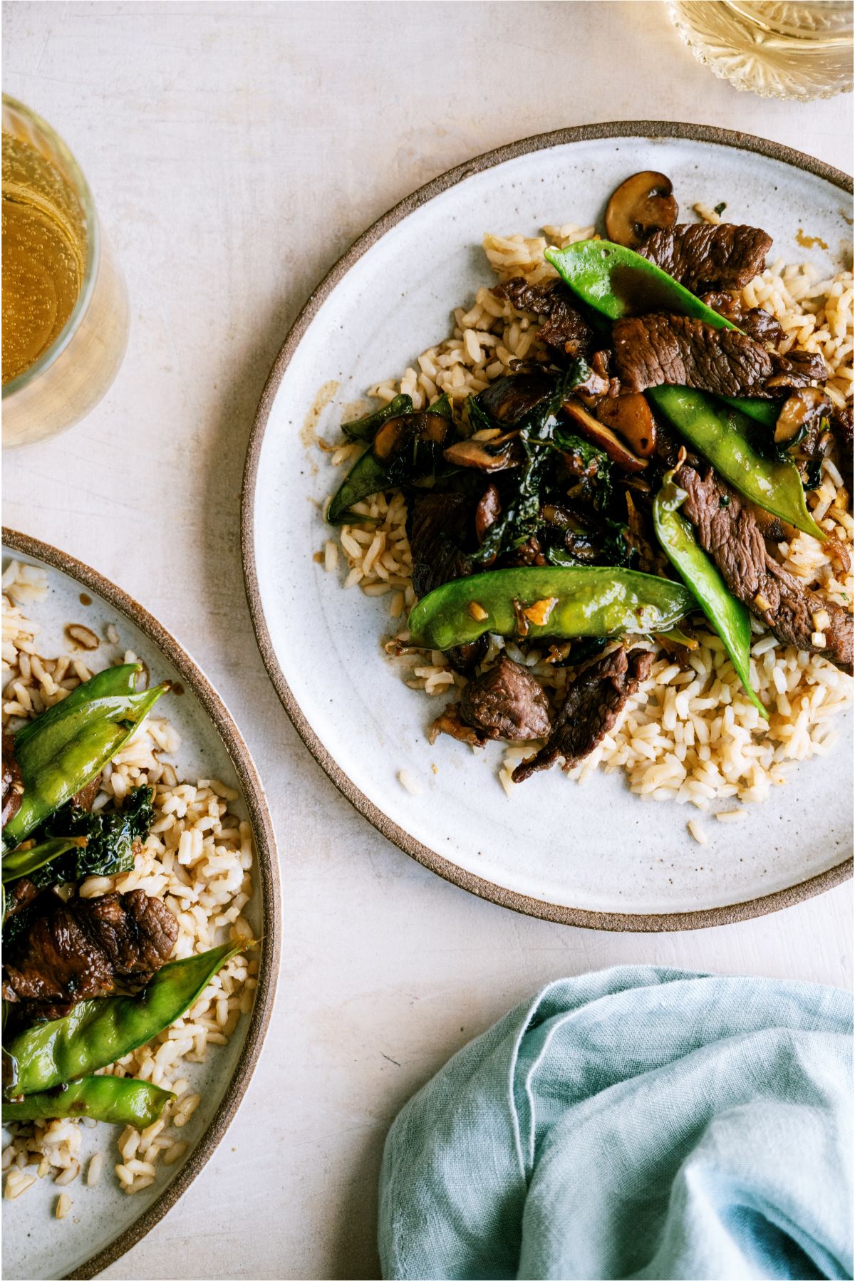 Two plated of Asian Beef and Snow Peas served over rice