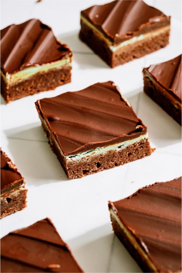 Chocolate Thin Mint Brownies cut into squares on a white background.