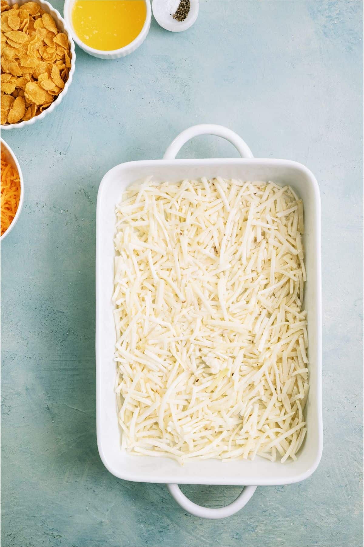 A casserole dish filled with shredded hashbrowns.