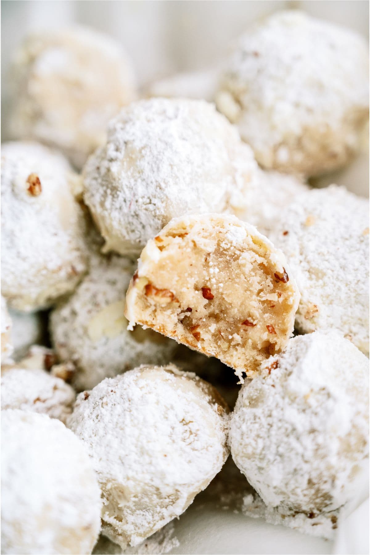 Mexican Wedding Cookies with one cut in half