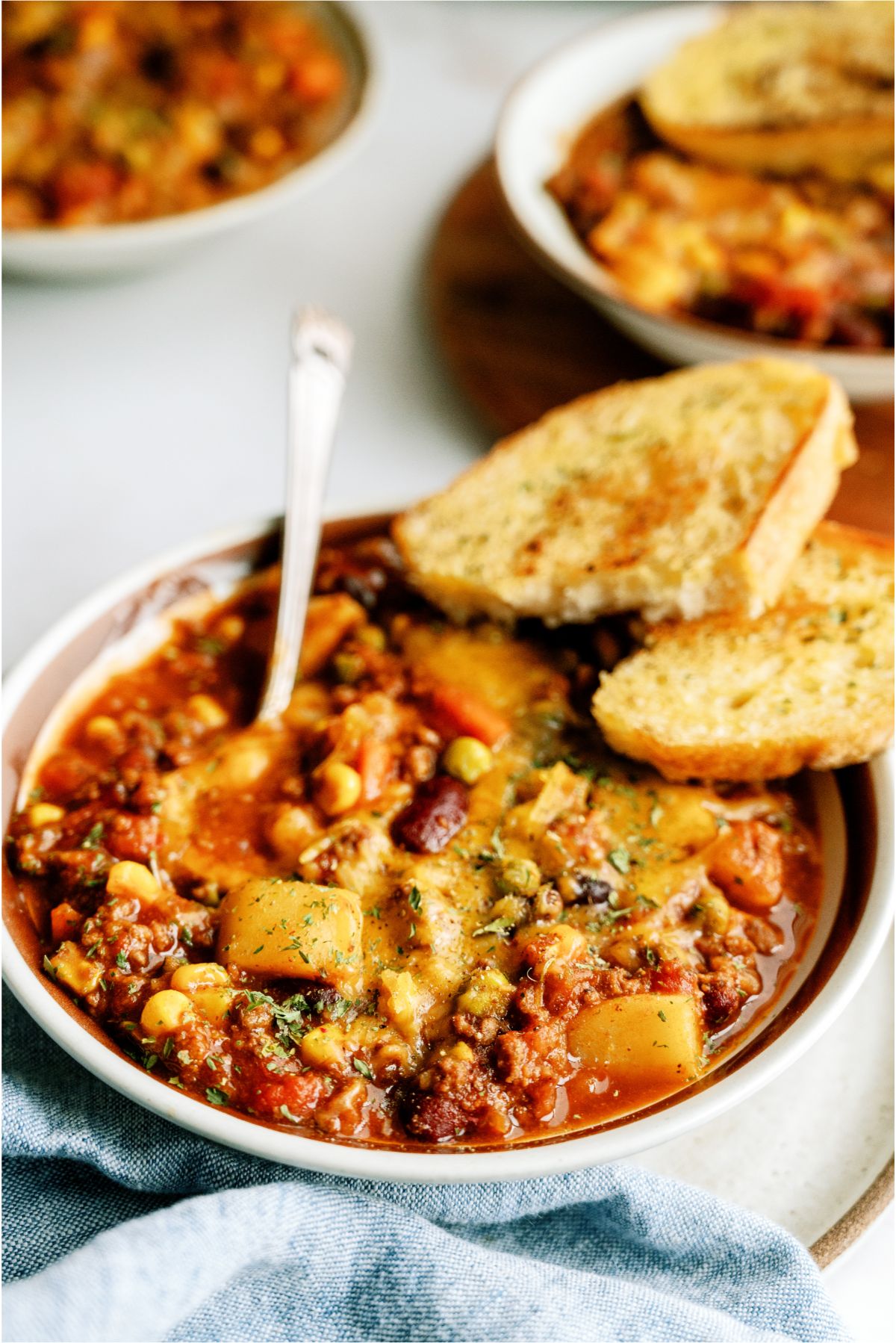 Bowls of Shepherd's Pie Chili with bread on the side