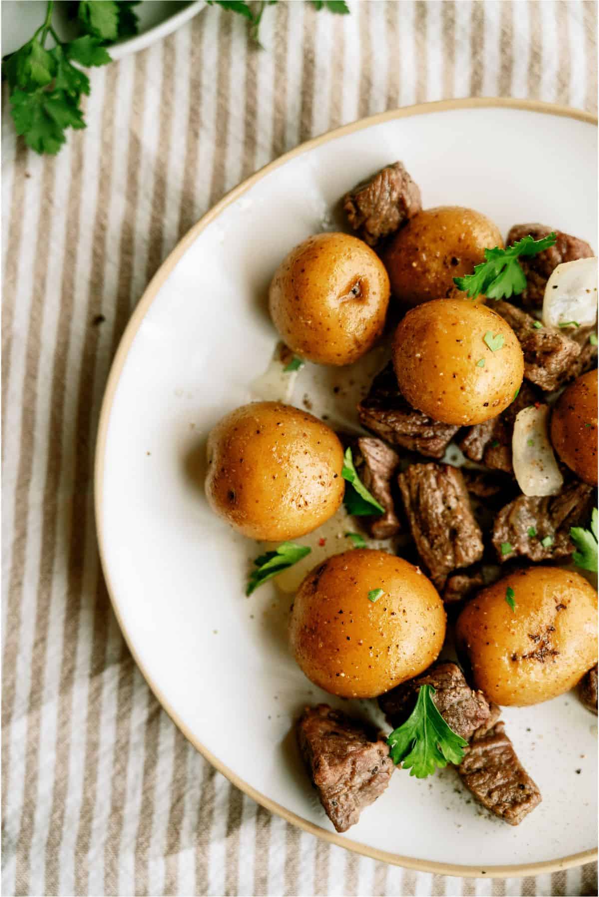 Slow Cooker Garlic Butter Steak and Potatoes on a plate