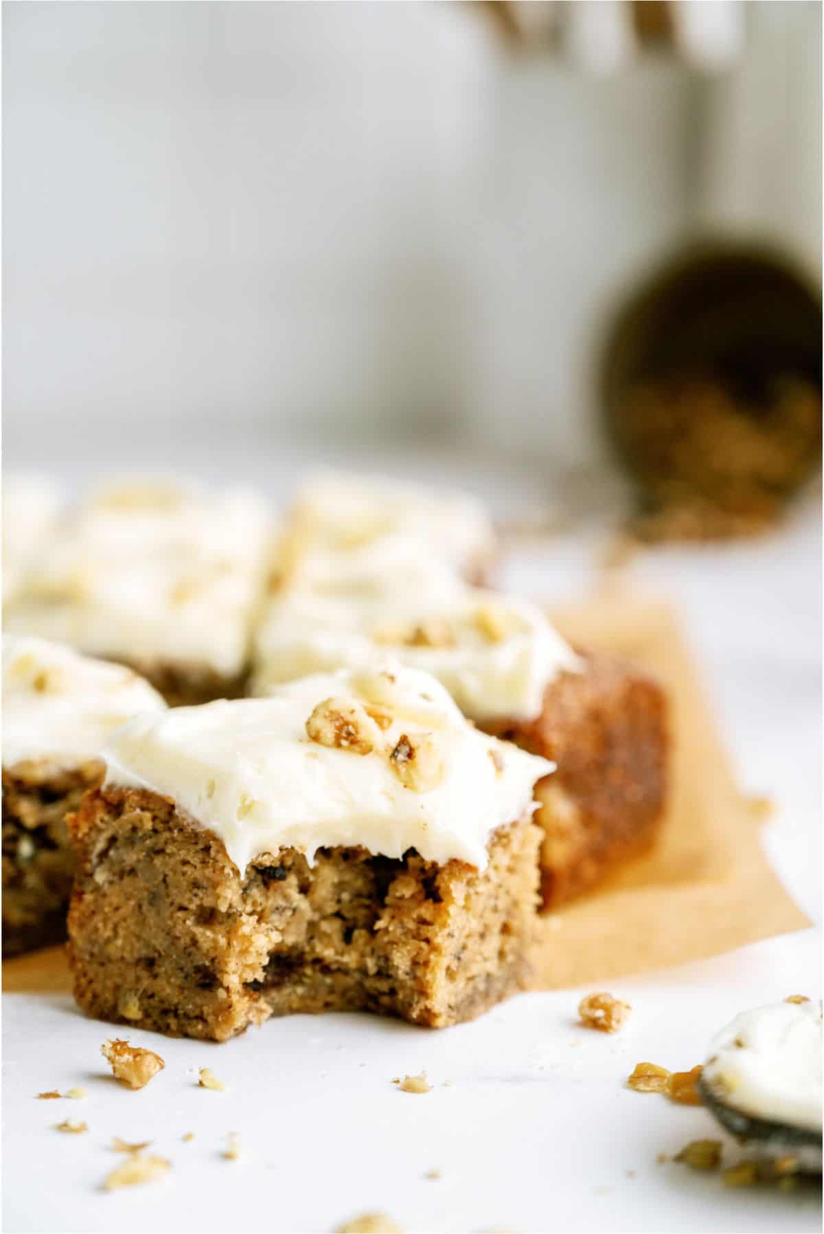 Banana Bread Brownies on a serving plate with one missing a bite