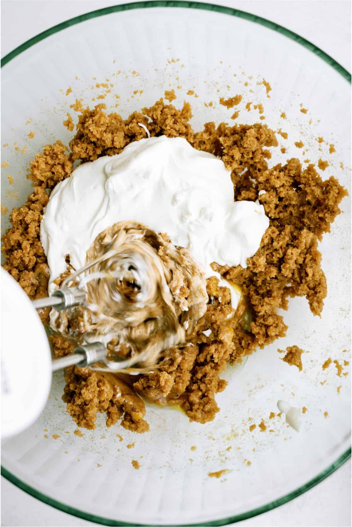 Ingredients for Banana Bread Brownies in a mixing bowl with a hand mixer