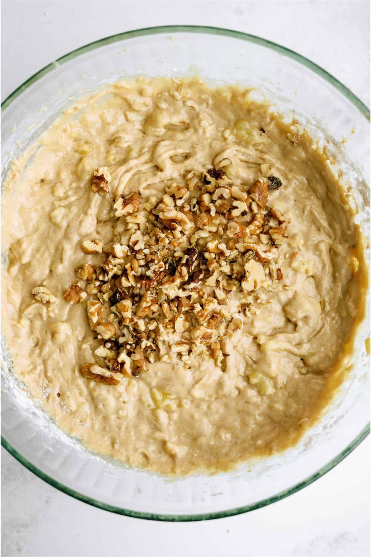 Adding walnuts to Banana Bread Brownies Batter in mixing bowl