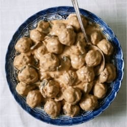A bowl of Crock Pot Swedish Meatballs with a serving spoon.