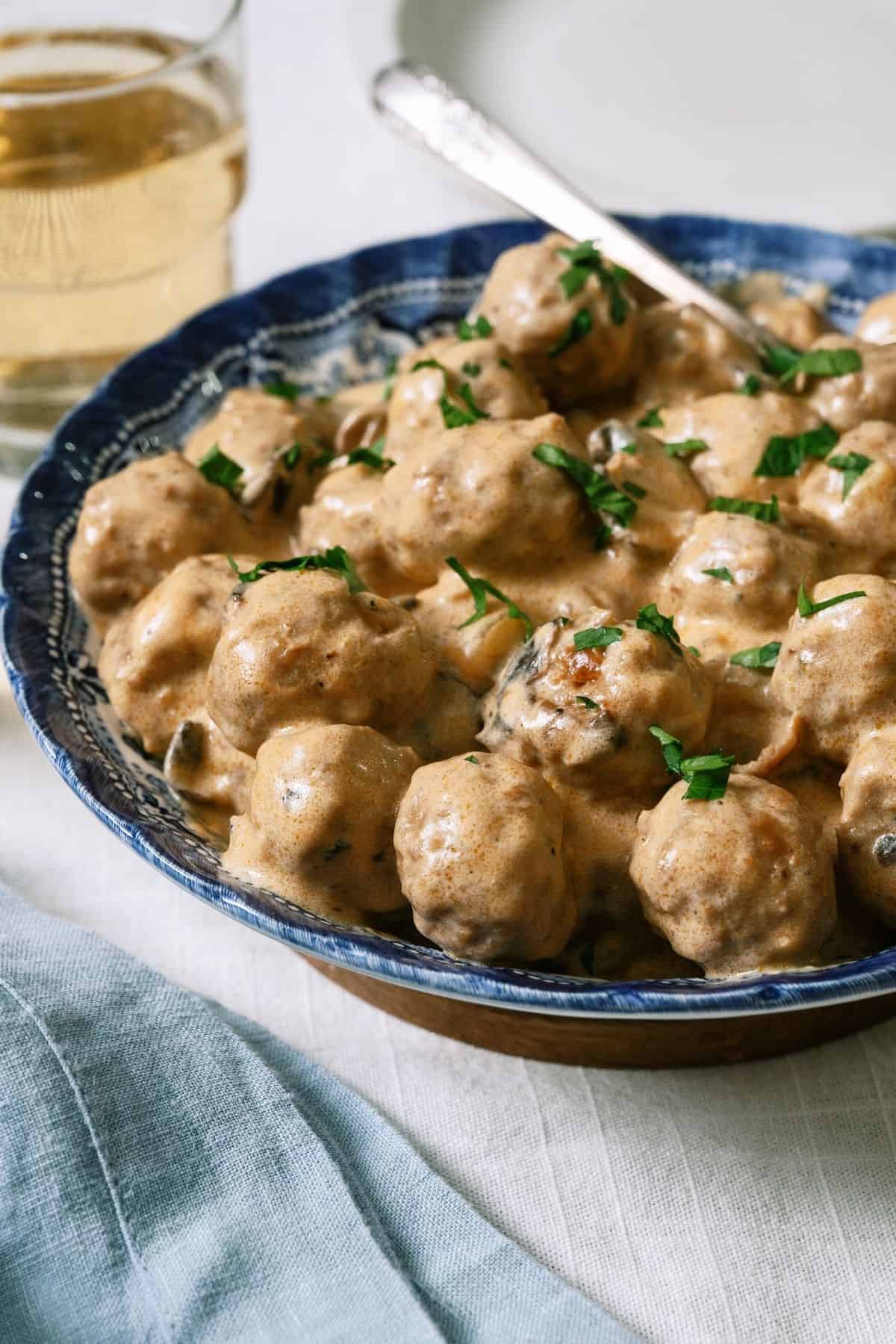 Side view of Crock Pot Swedish Meatballs in a serving bowl.
