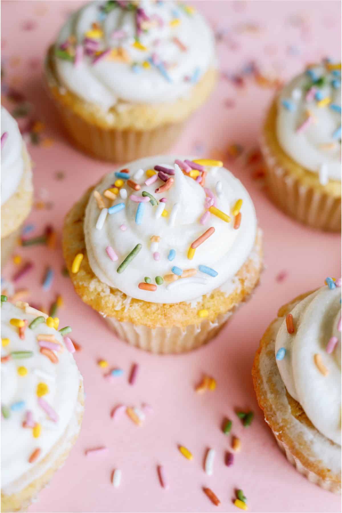 Top view of Easy Vanilla Cupcakes topped with buttercream frosting and sprinkles.