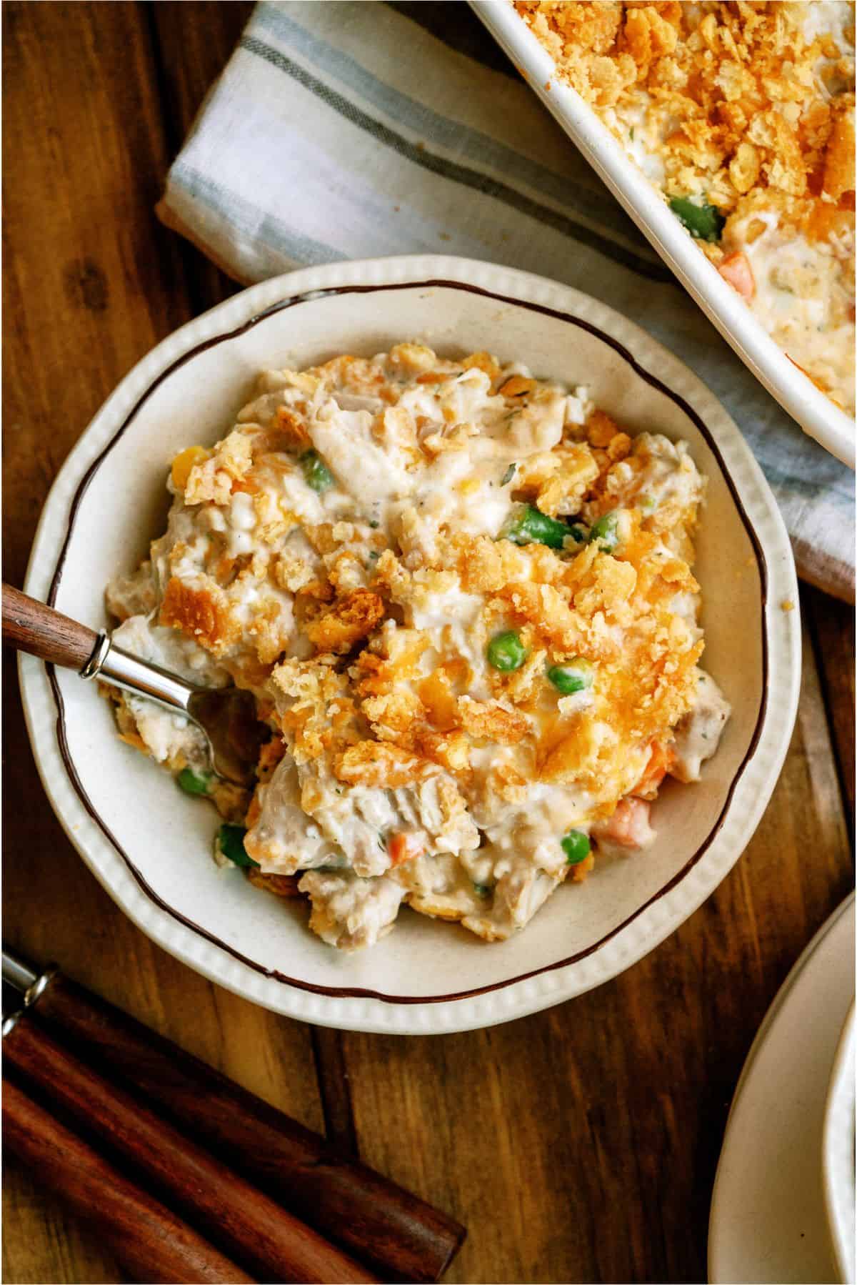 Top view of a serving of Million Dollar Chicken Casserole in a dish with a fork