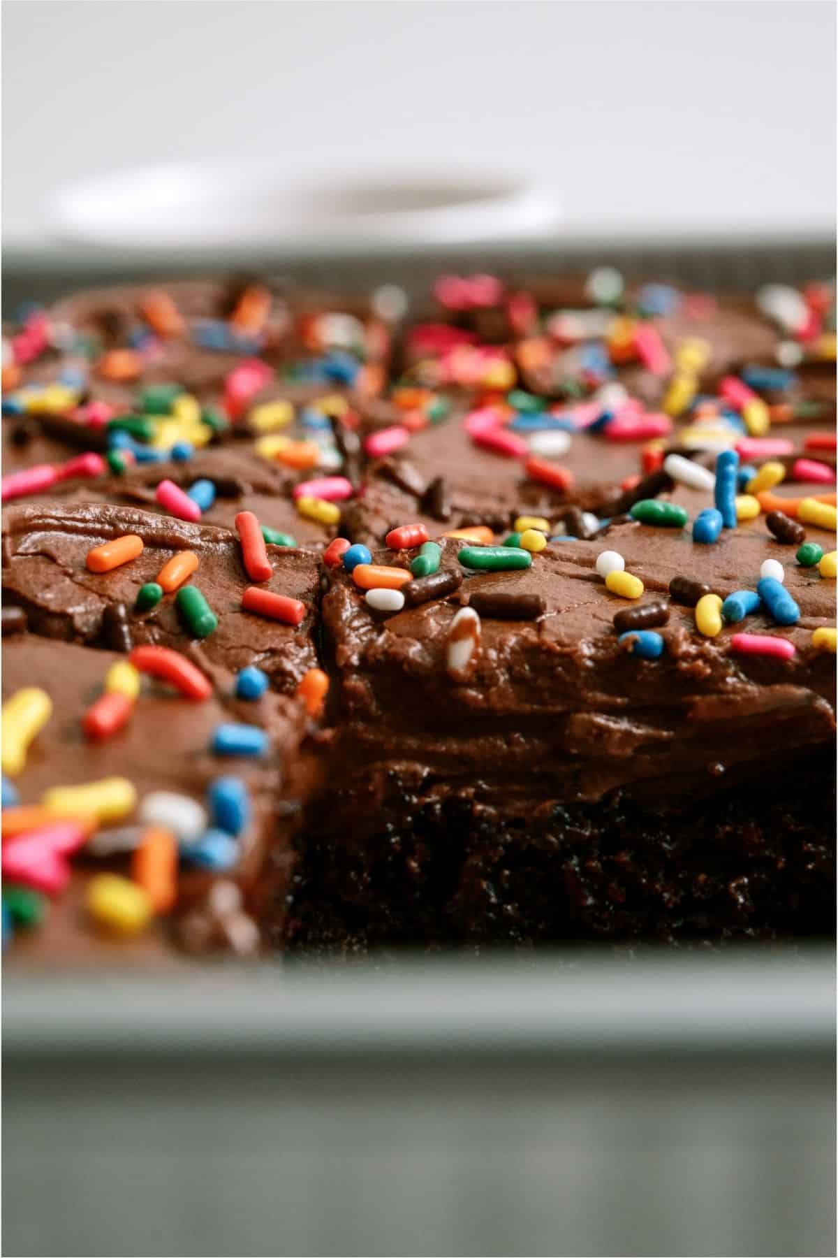A slice missing out of the pan of One Bowl Chocolate Cake.