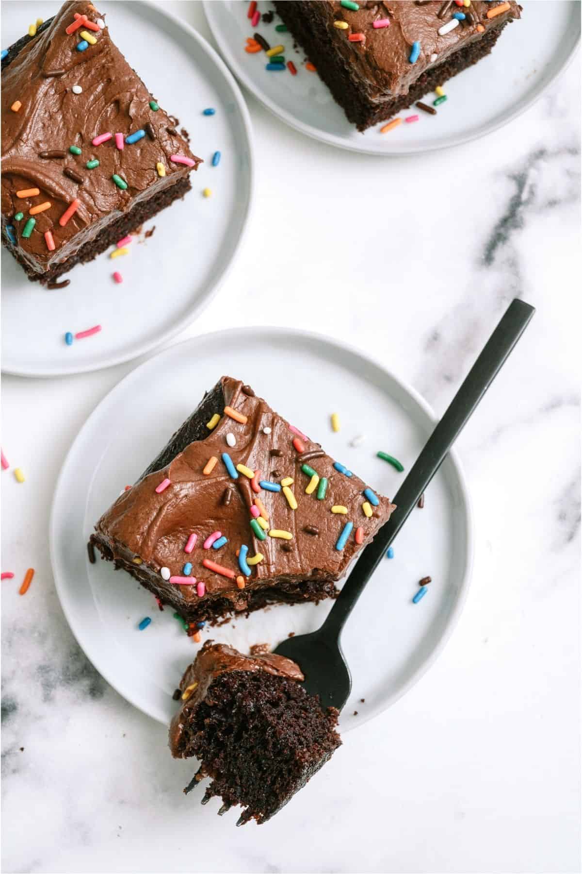 Top view of a slice of One Bowl Chocolate Cake with a bite sliced out with a fork.
