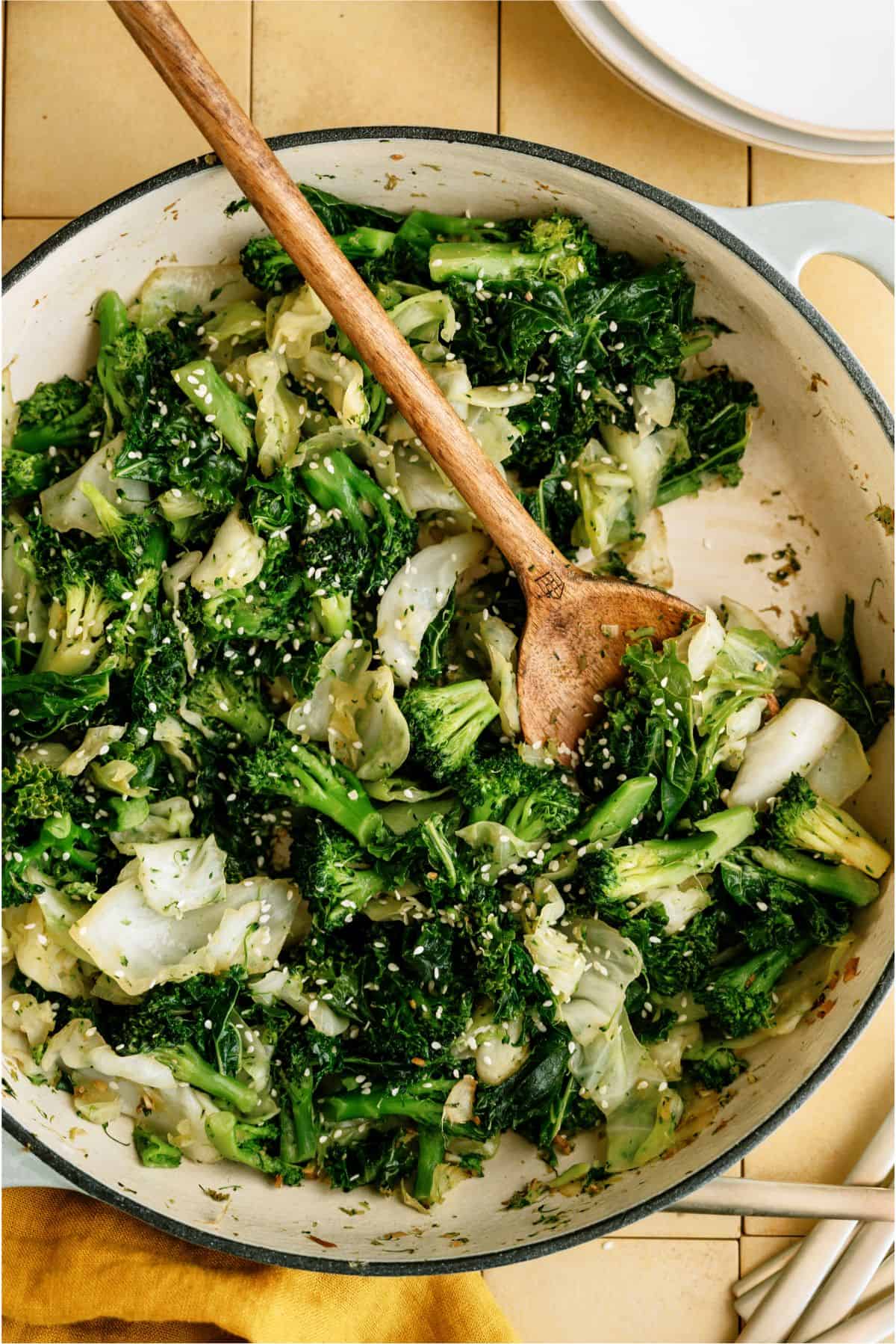 A skillet filled with Panda Express Super Greens and a wooden spoon