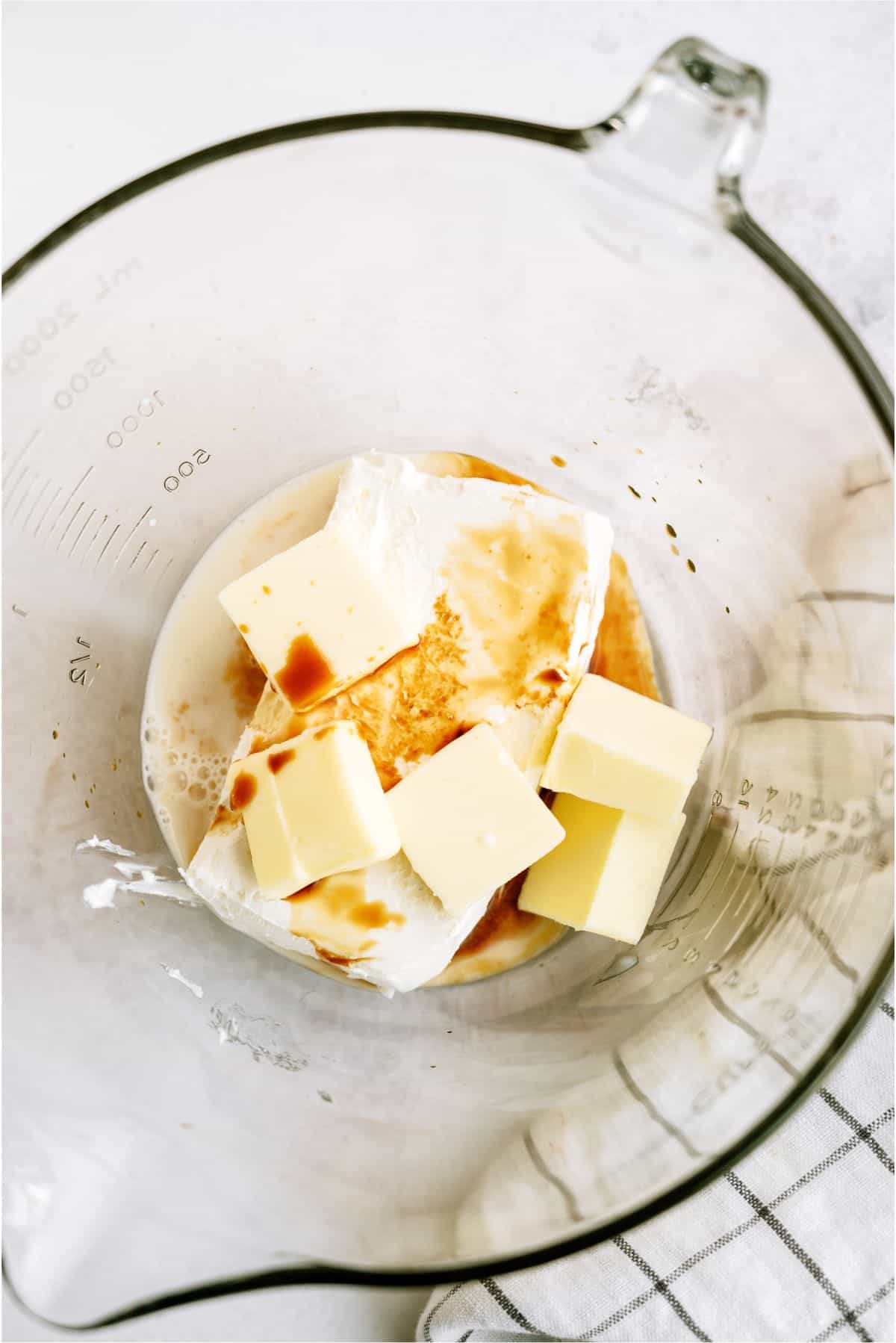 Large mixing bowl filled with ingredients for frosting.