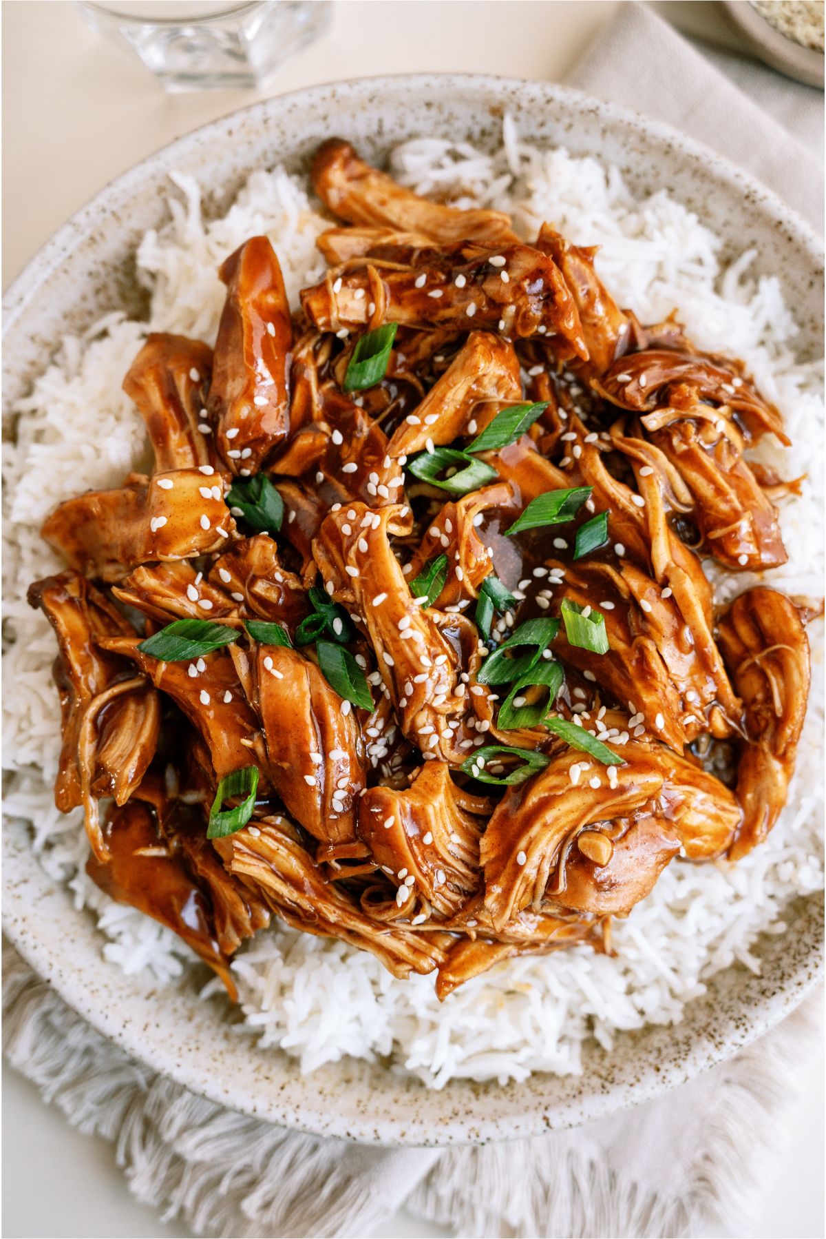 Top view of shredded Slow Cooker Asian Glazed Chicken on top of rice