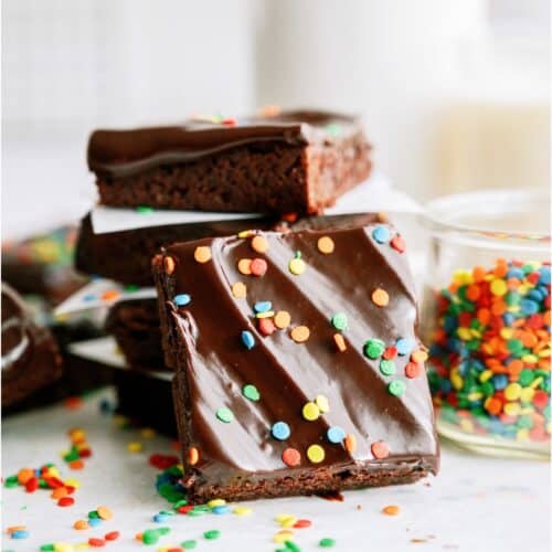 Copycat Cosmic Brownies stacked with one brownie leaning against the stack.