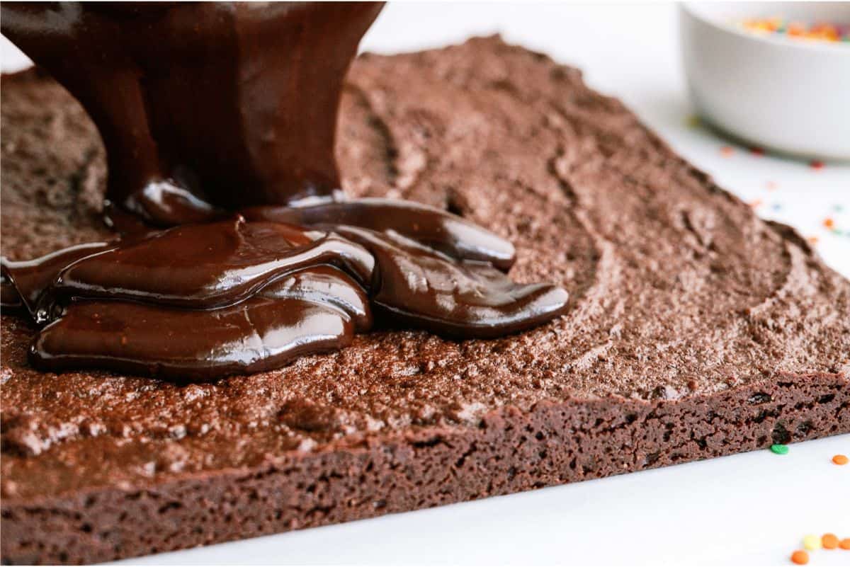 Spreading ganache on top of cooled baked brownies