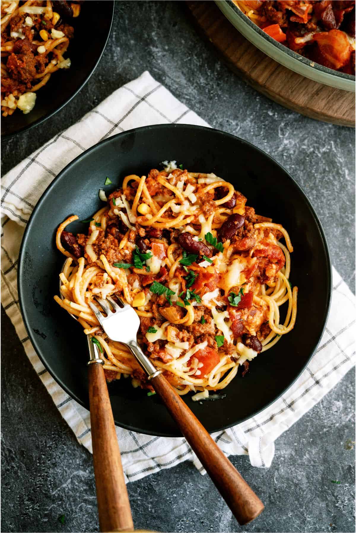 A plate of Skillet Cowboy Spaghetti with a fork and spoon