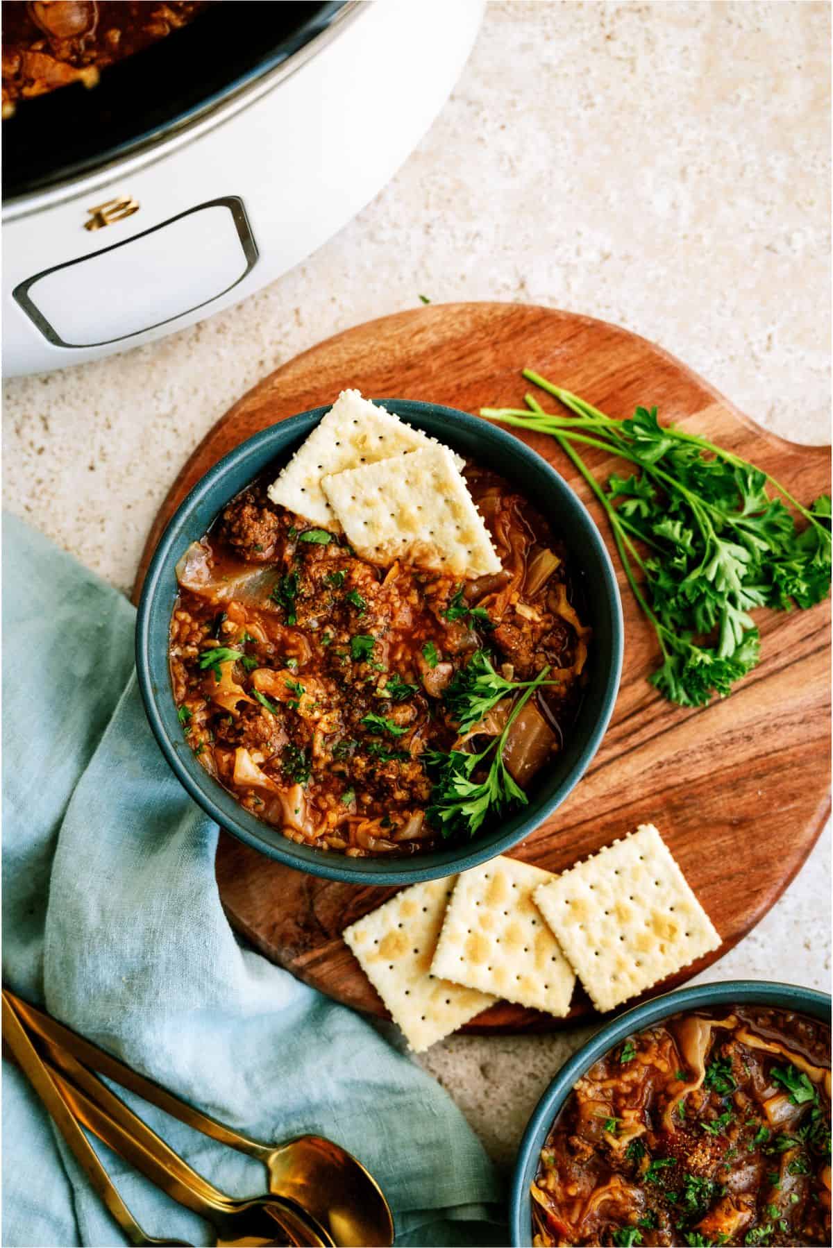 Top view of a bowl of Slow Cooker Cabbage Roll Soup with crackers