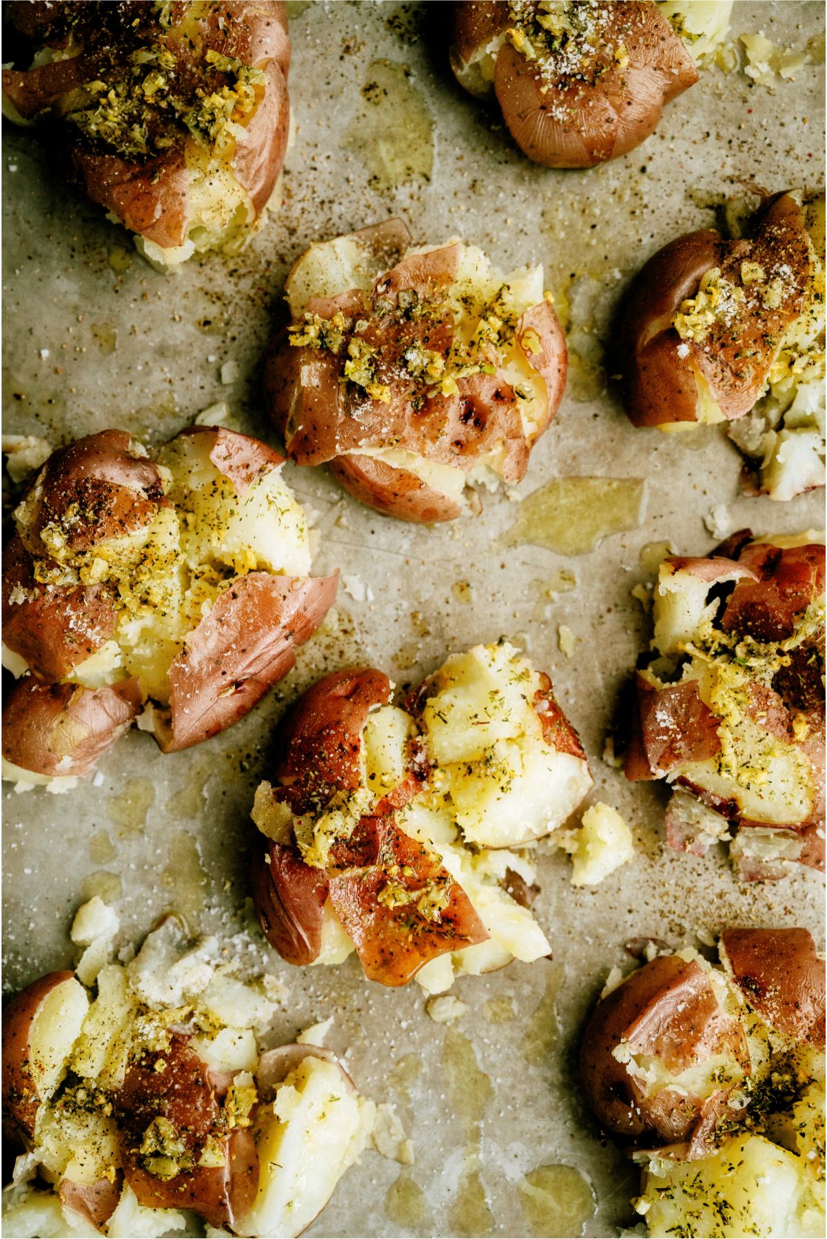 Top view of Smashed Italian Red Potatoes on a baking sheet
