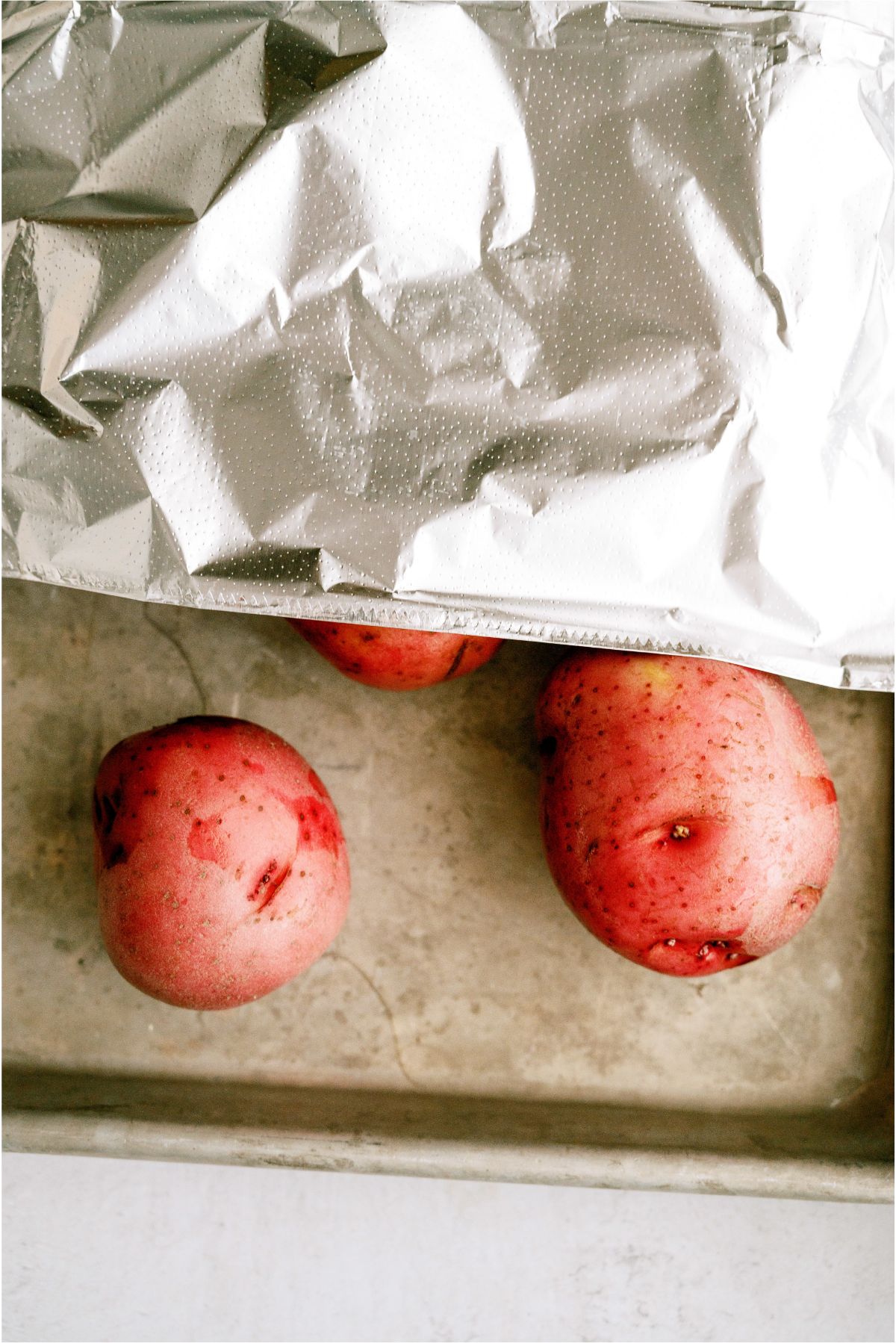 Red Potatoes on baking sheet covered with foil