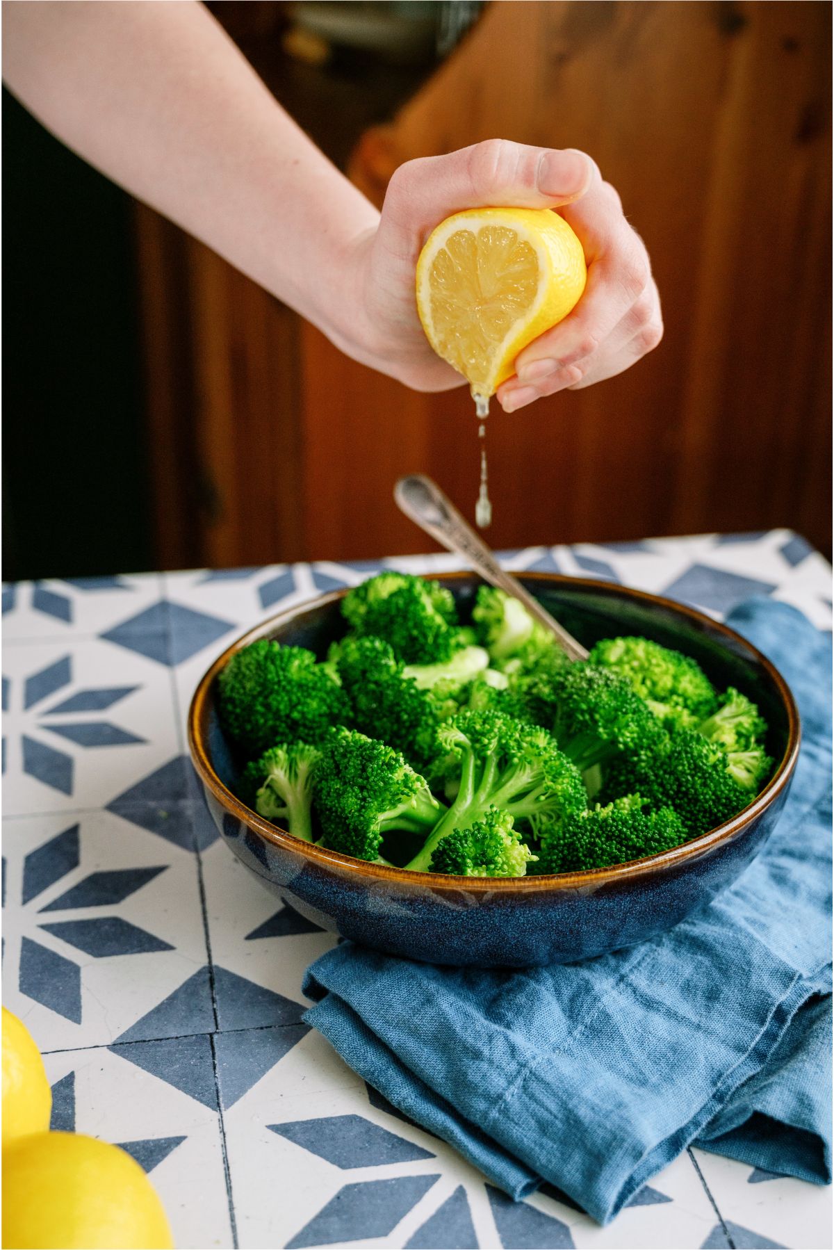 Squeezing fresh lemon on top of Steamed Broccoli