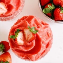 Top view of Strawberry Dole Whip in a glass with fresh strawberries.